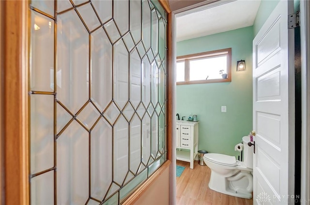 bathroom featuring wood-type flooring and toilet