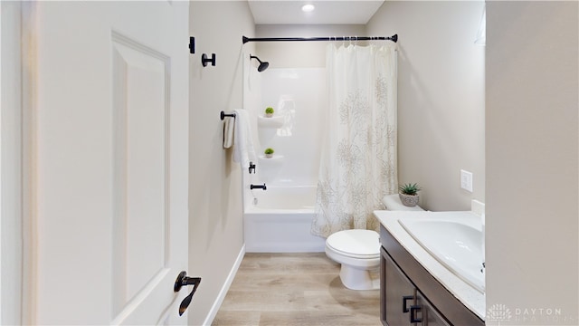 full bathroom with shower / bath combo, hardwood / wood-style flooring, toilet, and vanity