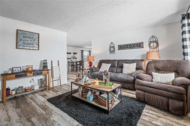 living room featuring a textured ceiling and hardwood / wood-style floors