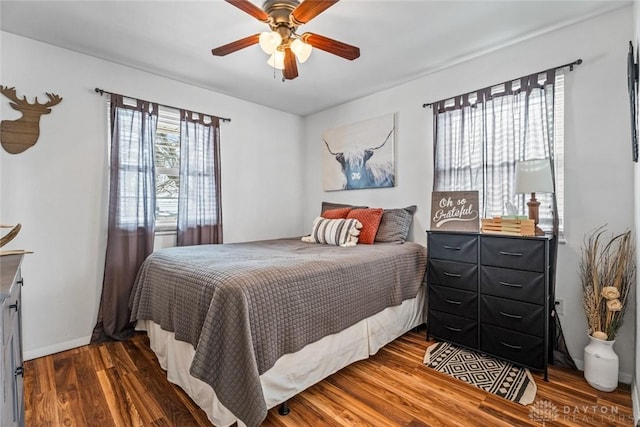 bedroom with ceiling fan and dark hardwood / wood-style flooring