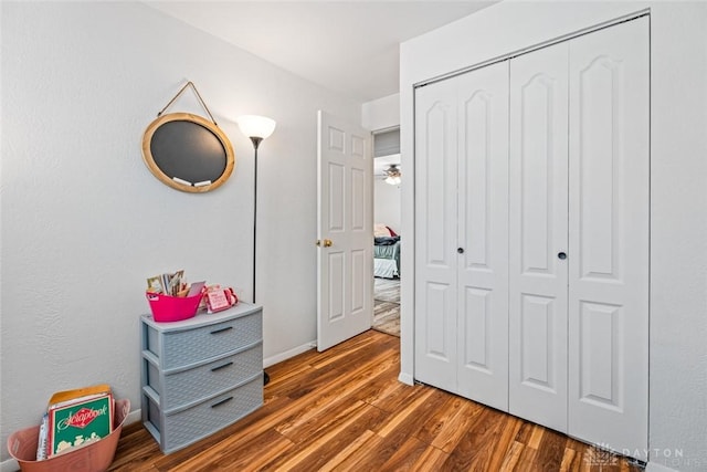 bedroom with a closet and dark wood-type flooring