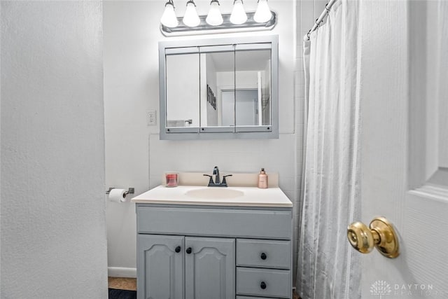 bathroom with vanity and curtained shower