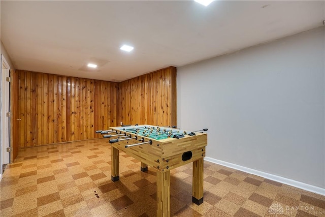 recreation room featuring wood walls