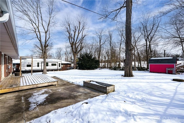 yard covered in snow featuring a wooden deck