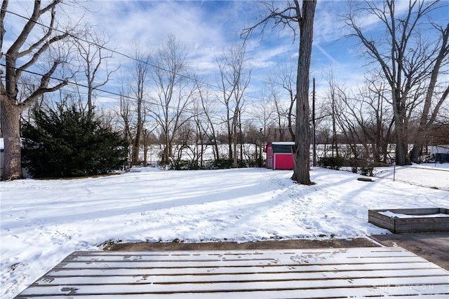 snowy yard with a shed