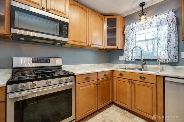 kitchen featuring sink, pendant lighting, and appliances with stainless steel finishes