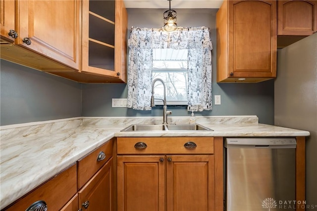 kitchen featuring decorative light fixtures, sink, and stainless steel dishwasher