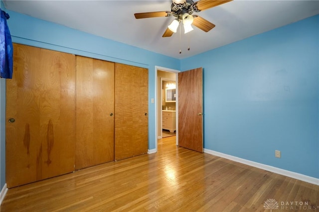 unfurnished bedroom with light wood-type flooring, a closet, and ceiling fan