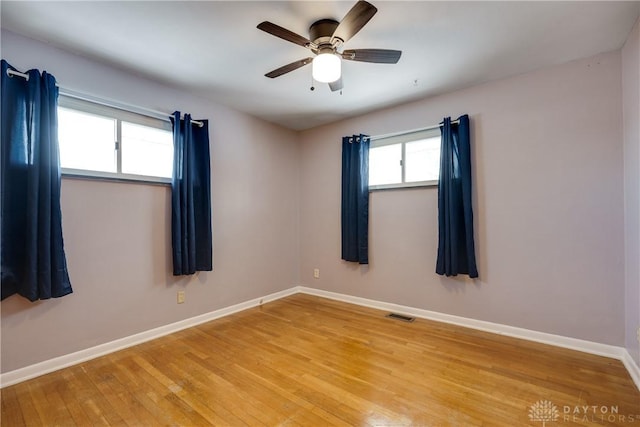 spare room featuring hardwood / wood-style flooring and ceiling fan