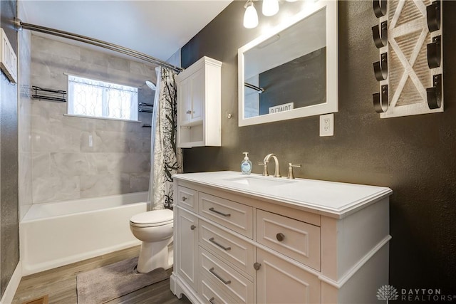 full bathroom with shower / bath combo with shower curtain, hardwood / wood-style flooring, toilet, and vanity