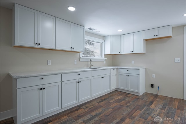 kitchen featuring sink, white cabinetry, and dark hardwood / wood-style flooring