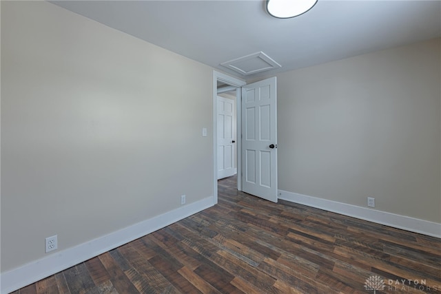 empty room with dark hardwood / wood-style flooring