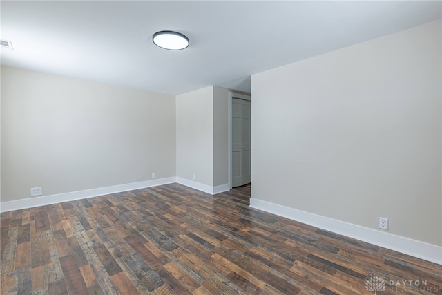 spare room with dark hardwood / wood-style floors