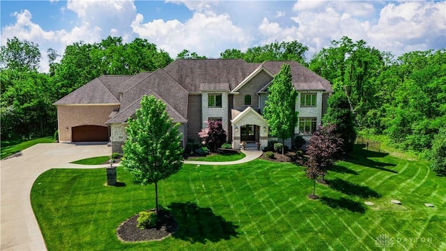 view of front of house with a garage and a front yard