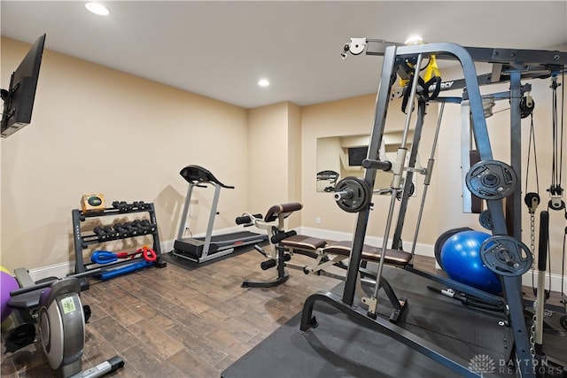 workout area with dark wood-type flooring