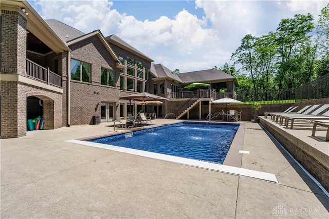 view of pool with a patio area and pool water feature