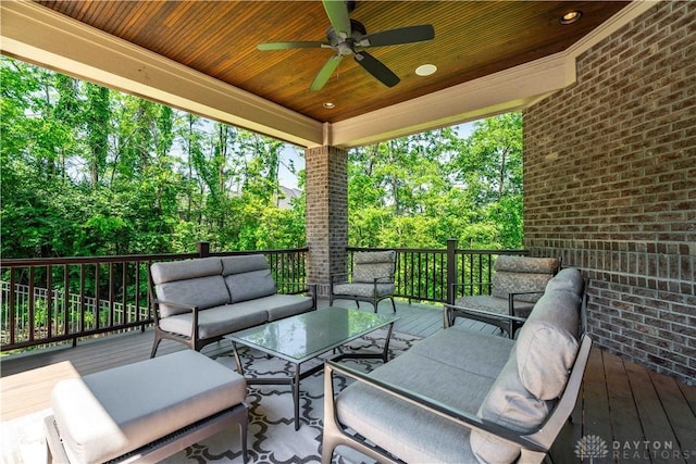 wooden deck with ceiling fan and an outdoor living space