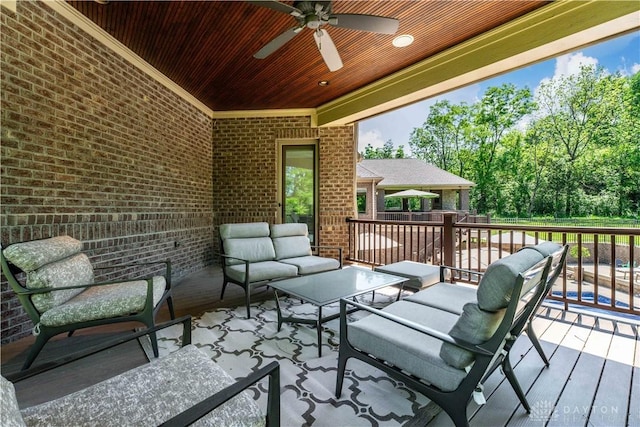 wooden deck featuring an outdoor living space and ceiling fan