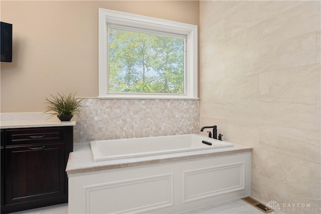 bathroom featuring a bathing tub and tile walls