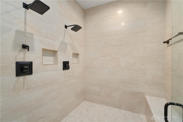 bathroom with tiled shower