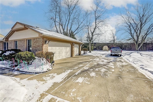 view of snowy exterior featuring a garage