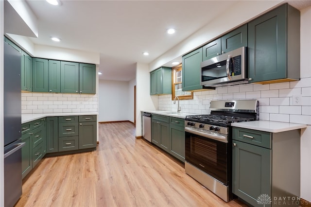 kitchen with stainless steel appliances and green cabinets