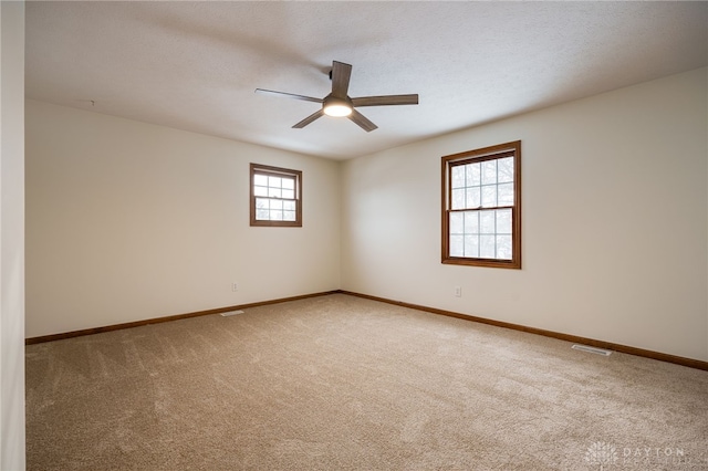 spare room with ceiling fan and carpet flooring