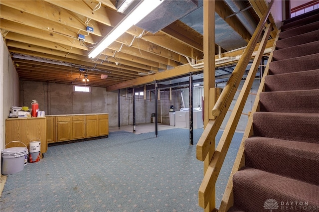 basement featuring independent washer and dryer and carpet flooring