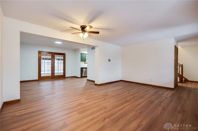 unfurnished living room with ceiling fan and wood-type flooring