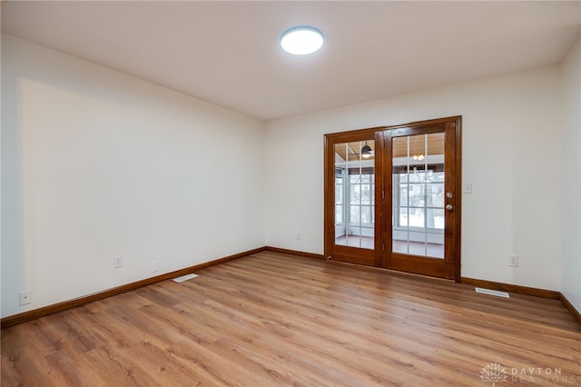 spare room featuring light wood-type flooring