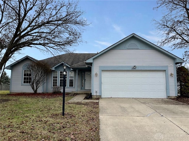 ranch-style house featuring a garage and a front yard