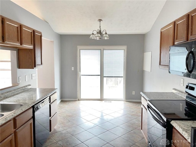 kitchen with brown cabinets, hanging light fixtures, black appliances, and light tile patterned floors