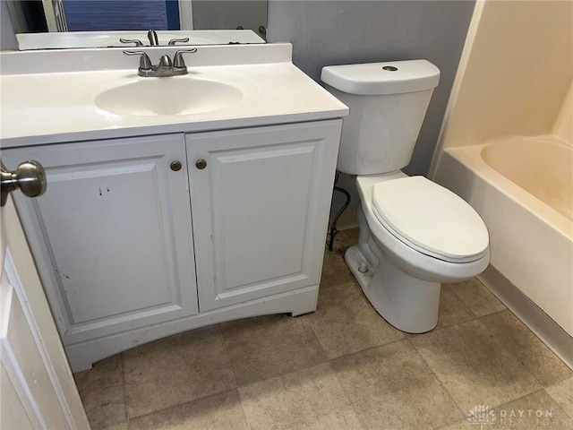 bathroom featuring toilet, a tub to relax in, a shower, and vanity