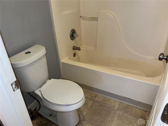 bathroom featuring tub / shower combination and toilet