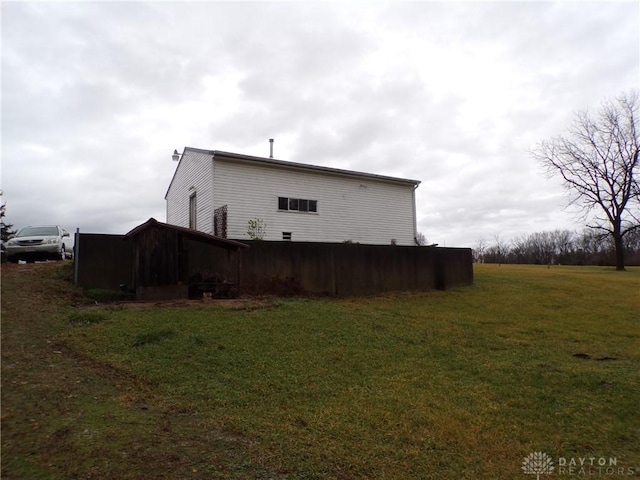 view of side of property with a yard