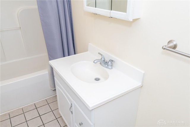 bathroom with vanity, shower / bathtub combination with curtain, and tile patterned flooring