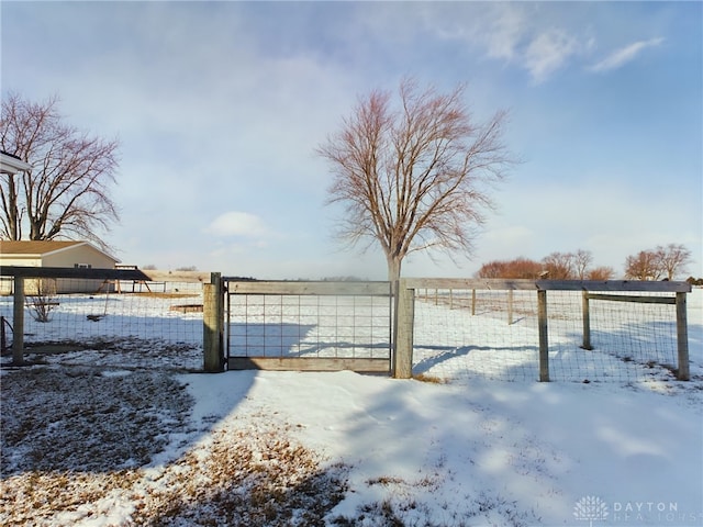 yard layered in snow with a rural view