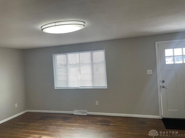 entrance foyer featuring dark wood-type flooring and a wealth of natural light