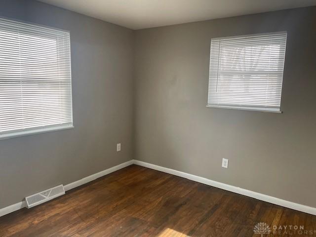 empty room featuring dark wood-type flooring