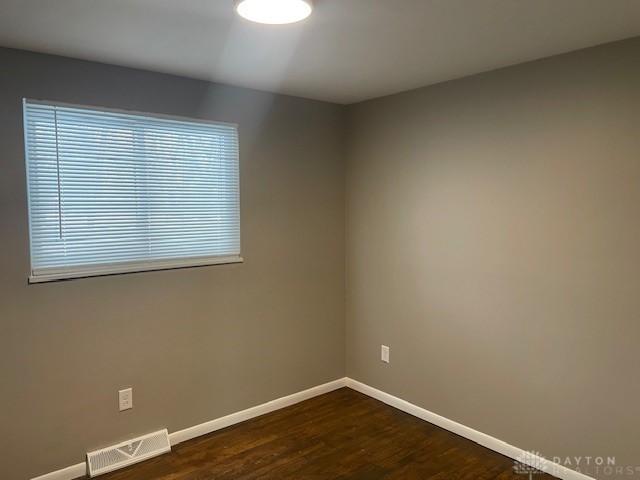 unfurnished room featuring dark hardwood / wood-style floors