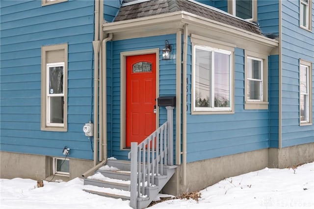 view of snow covered property entrance