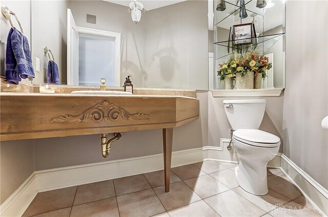 bathroom featuring sink, tile patterned floors, and toilet