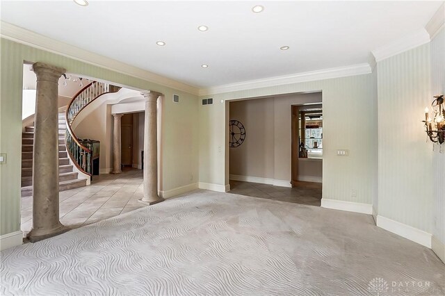 unfurnished room with ornamental molding and ornate columns