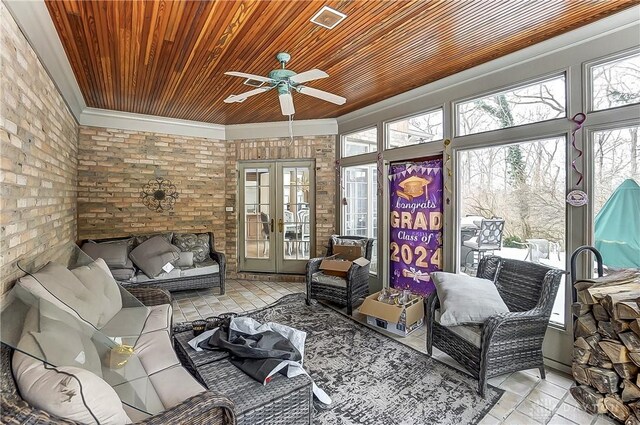 sunroom / solarium featuring wood ceiling, plenty of natural light, and french doors