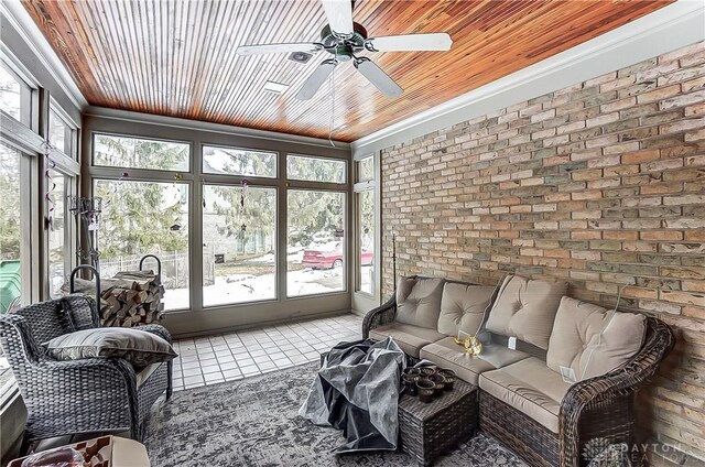 sunroom featuring wood ceiling and ceiling fan