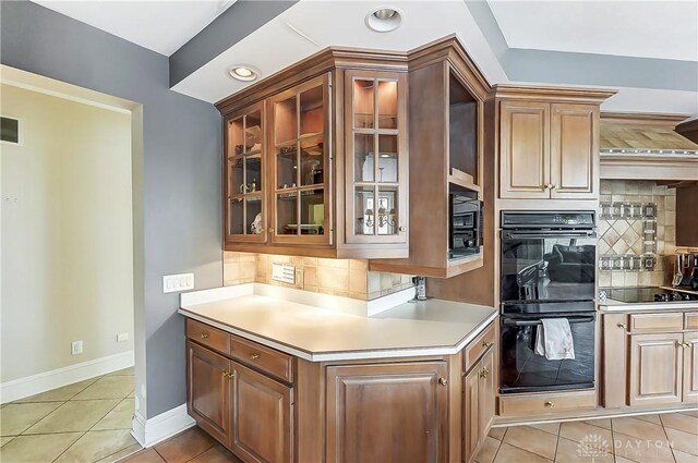 kitchen featuring tasteful backsplash, light tile patterned floors, and black appliances