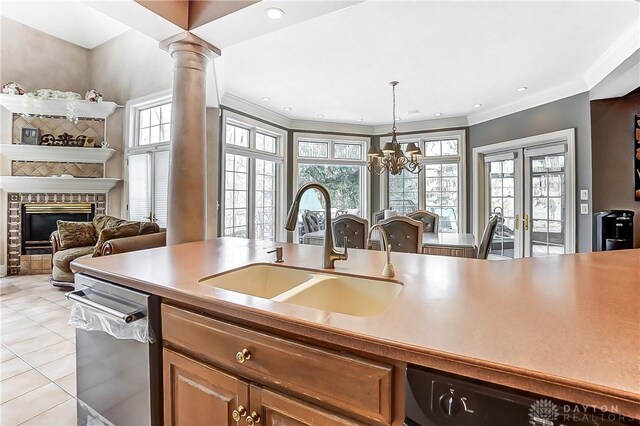 kitchen with decorative columns, dishwasher, sink, stainless steel dishwasher, and french doors