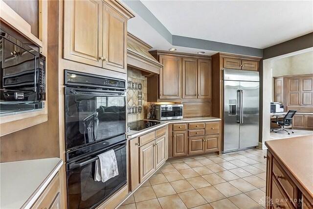 kitchen featuring tasteful backsplash, black appliances, and light tile patterned flooring