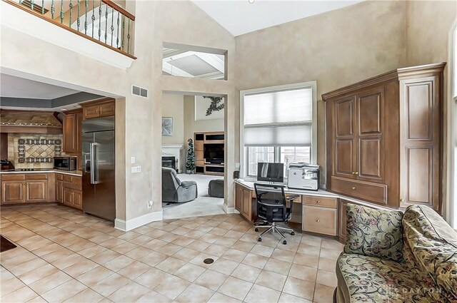 home office featuring light tile patterned floors and a high ceiling