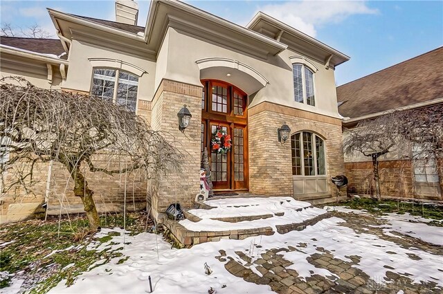 view of snow covered property entrance